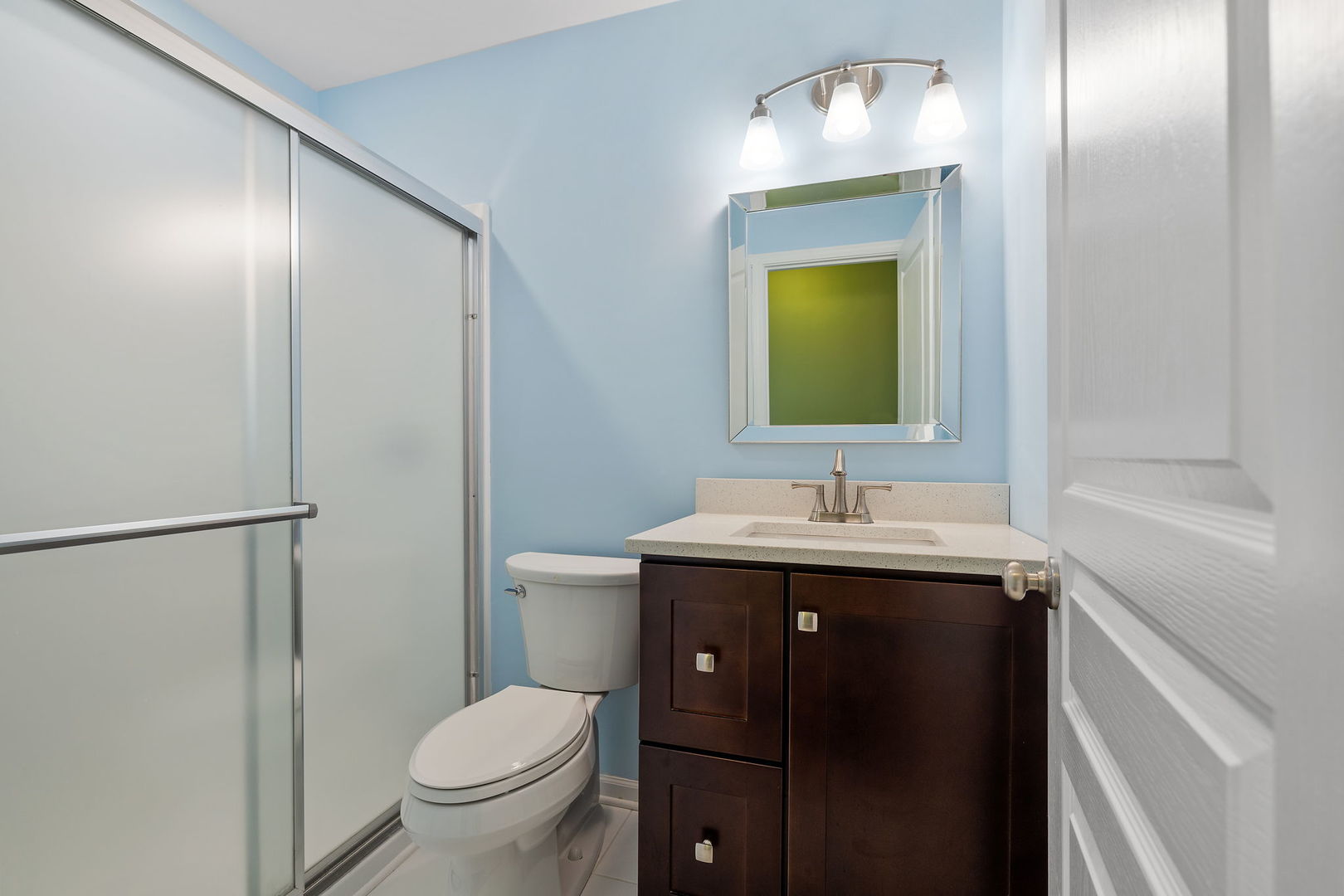 15341 Pinewood Road, Unit 15341 Lockport, IL 60441 - Photo 19 of 21 a bathroom with a toilet a sink and mirror