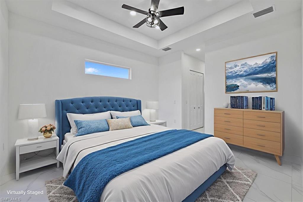 3812 9th Street Southwest Lehigh Acres, FL 33976 - Photo 14 of 39 a bedroom with a bed and ceiling fan