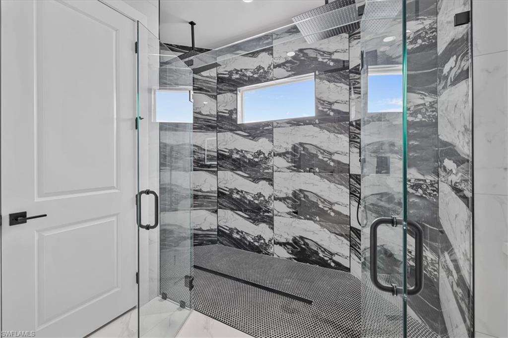 3812 9th Street Southwest Lehigh Acres, FL 33976 - Photo 18 of 39 a bathroom with a shower