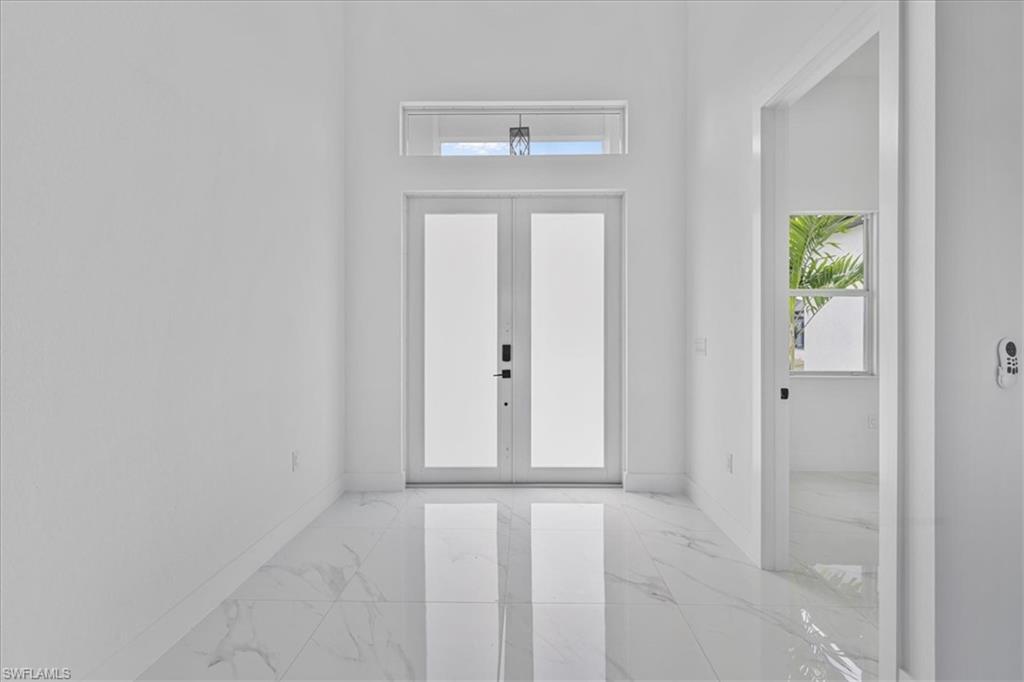 3812 9th Street Southwest Lehigh Acres, FL 33976 - Photo 2 of 39 wooden floor in an empty room