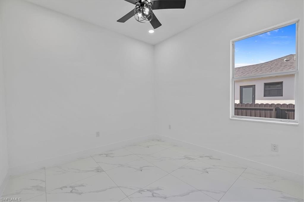 3812 9th Street Southwest Lehigh Acres, FL 33976 - Photo 20 of 39 a view of an empty room with a window