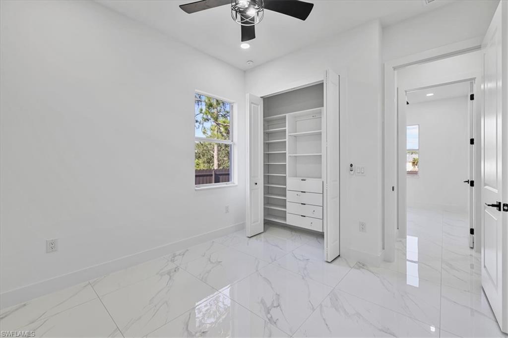 3812 9th Street Southwest Lehigh Acres, FL 33976 - Photo 22 of 39 an empty room with windows and closet