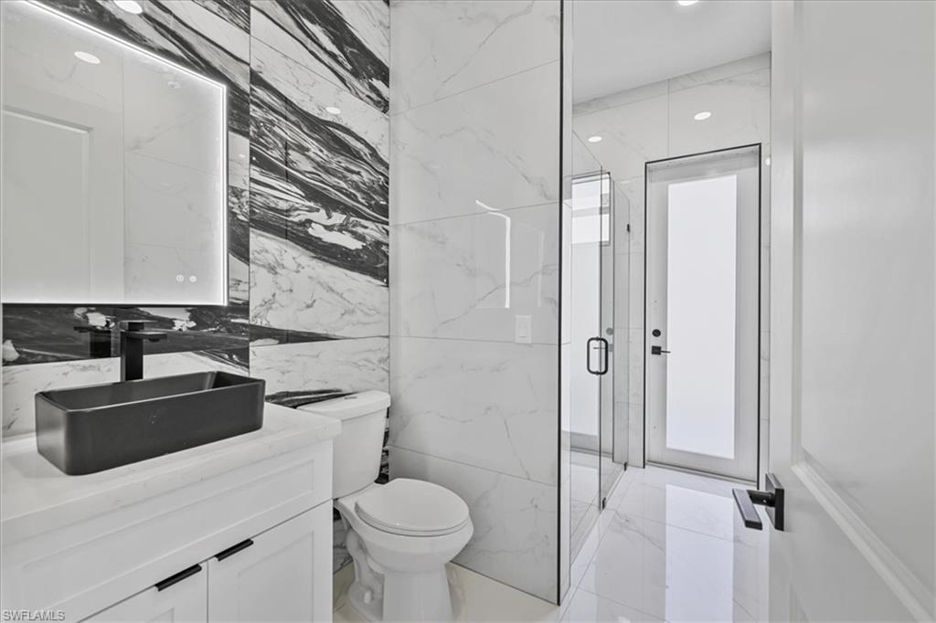 3812 9th Street Southwest Lehigh Acres, FL 33976 - Photo 23 of 39 a bathroom with a sink toilet and shower