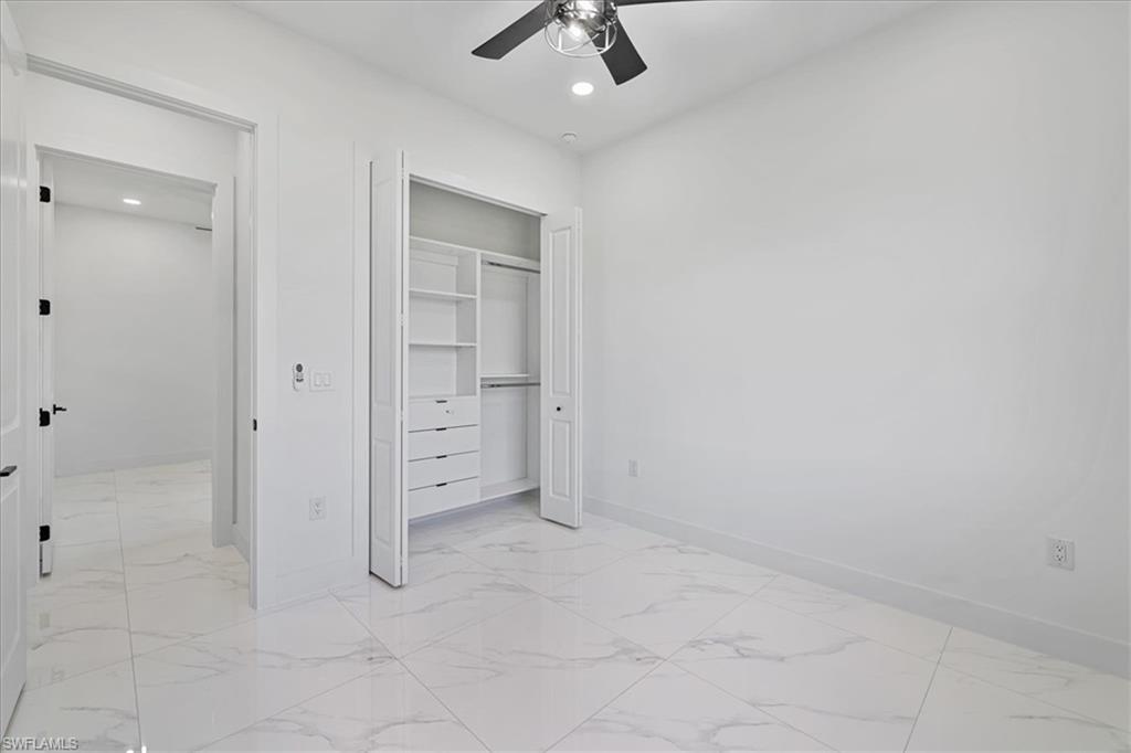 3812 9th Street Southwest Lehigh Acres, FL 33976 - Photo 27 of 39 wooden floor in an empty room