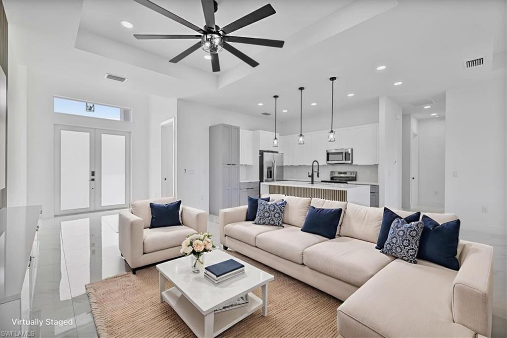 3812 9th Street Southwest Lehigh Acres, FL 33976 - Photo 3 of 39 a living room with furniture and a view of kitchen