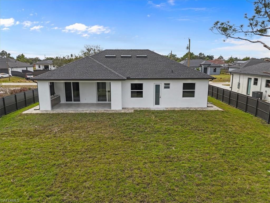 3812 9th Street Southwest Lehigh Acres, FL 33976 - Photo 32 of 39 a front view of a house with a yard