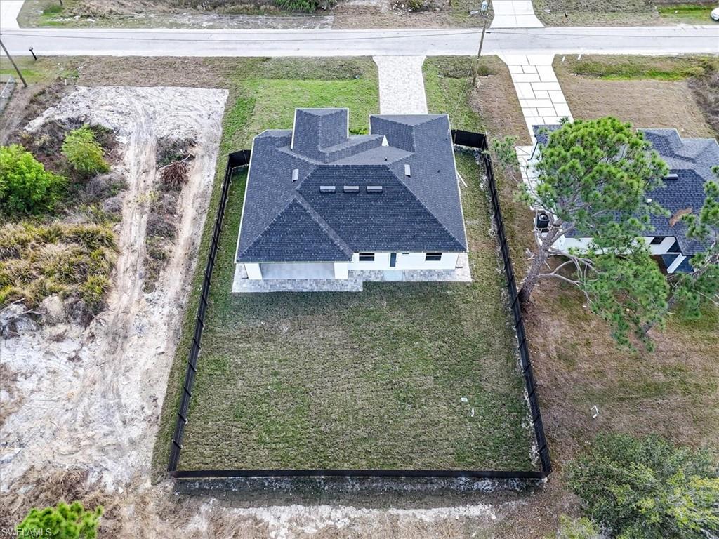 3812 9th Street Southwest Lehigh Acres, FL 33976 - Photo 35 of 39 an aerial view of a house with a yard
