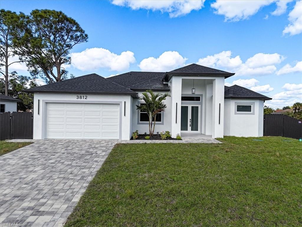 3812 9th Street Southwest Lehigh Acres, FL 33976 - Photo 38 of 39 a front view of a house with garden