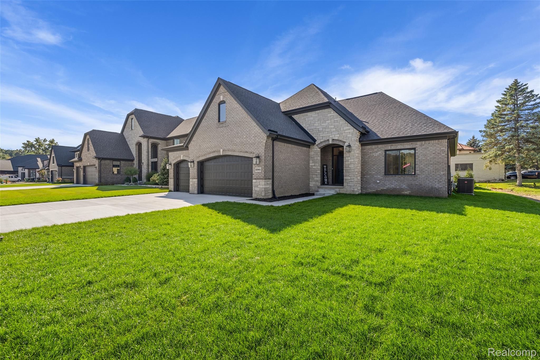 8267 Sandi Lane Romeo, MI 48065 - Photo 9 of 46 Brick and stone exterior with dark trim and a prominent arched entryway