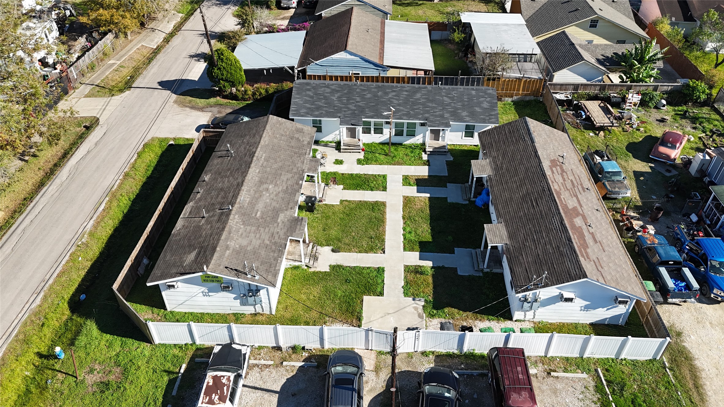 an aerial view of a residential apartment building with a yard and seating area