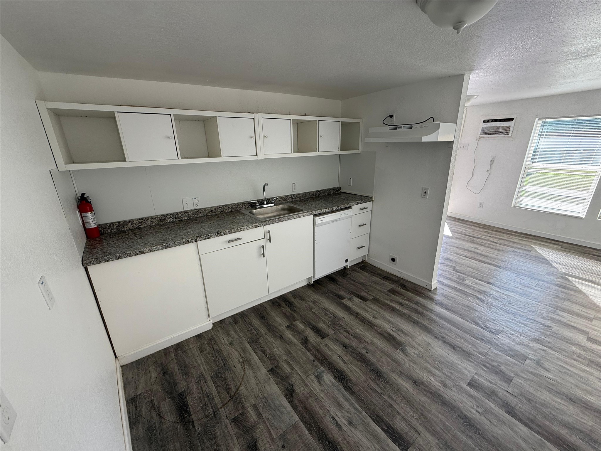 6901 Dumble Street Houston, TX 77021 - Photo 11 of 26 a kitchen with granite countertop white cabinets and wooden floor