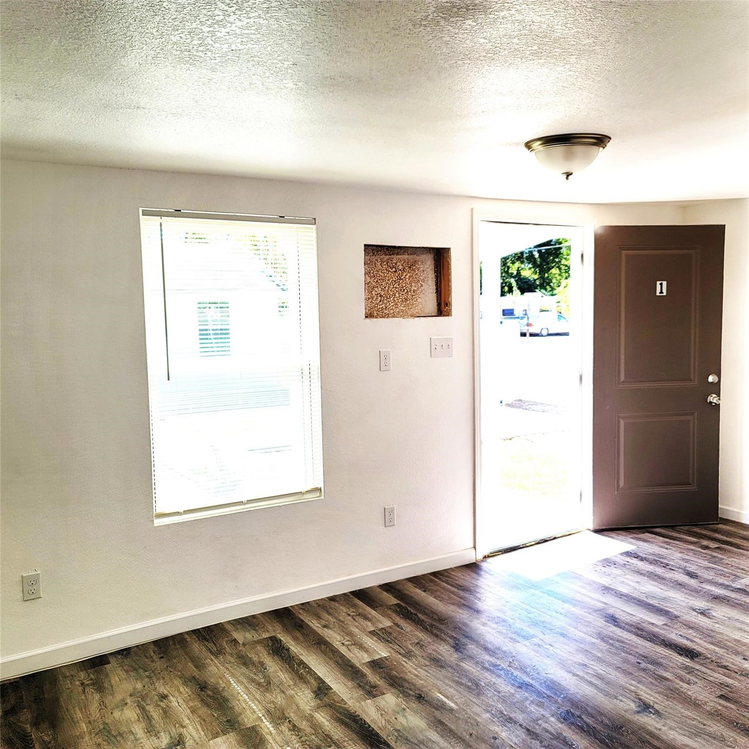 6901 Dumble Street Houston, TX 77021 - Photo 14 of 26 an empty room with wooden floor and windows