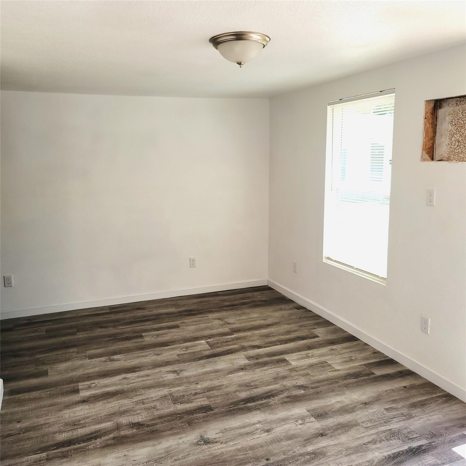6901 Dumble Street Houston, TX 77021 - Photo 22 of 26 a view of an empty room with wooden floor and a window