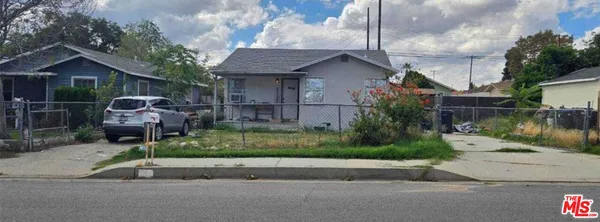 a front view of house with a garden
