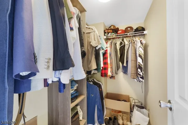 a view of walk in closet with clothes