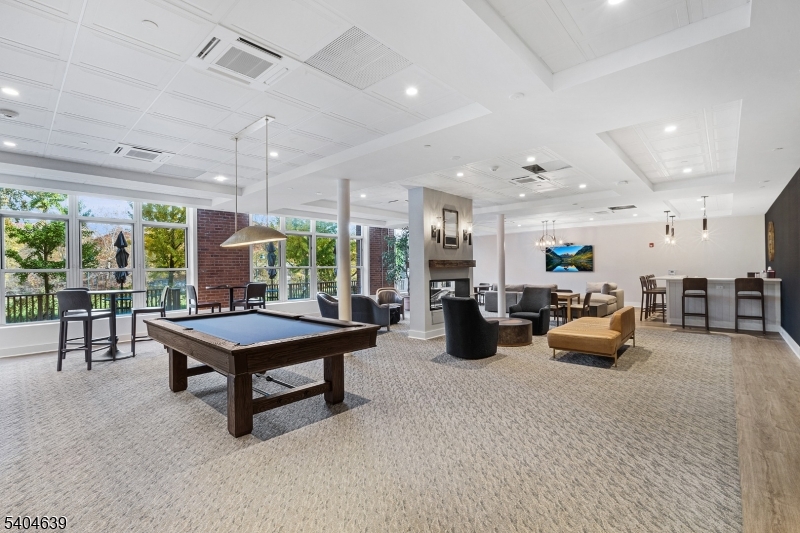 300 Main Street, Unit 416 Little Falls, NJ 07424 - Photo 14 of 19 a room with lots of furniture and a potted plant