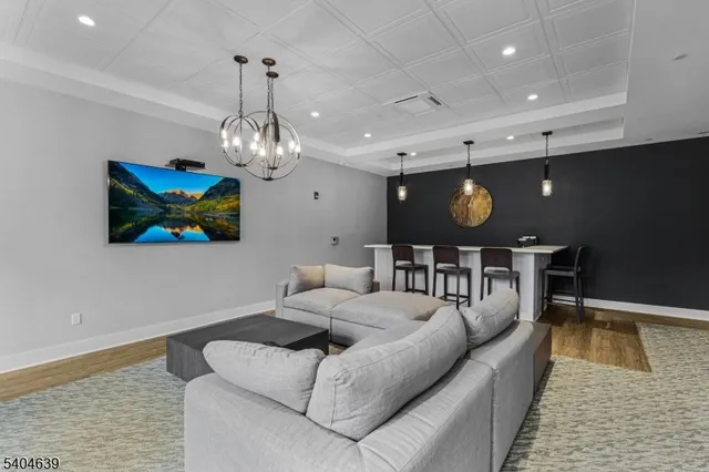 a living room with furniture and a chandelier