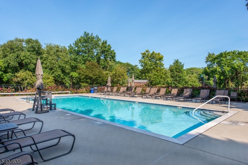 300 Main Street, Unit 416 Little Falls, NJ 07424 - Photo 18 of 19 a view of a swimming pool with a patio and a yard