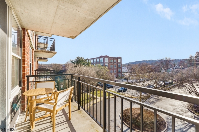 300 Main Street, Unit 416 Little Falls, NJ 07424 - Photo 7 of 19 a view of a city from a balcony with seating space