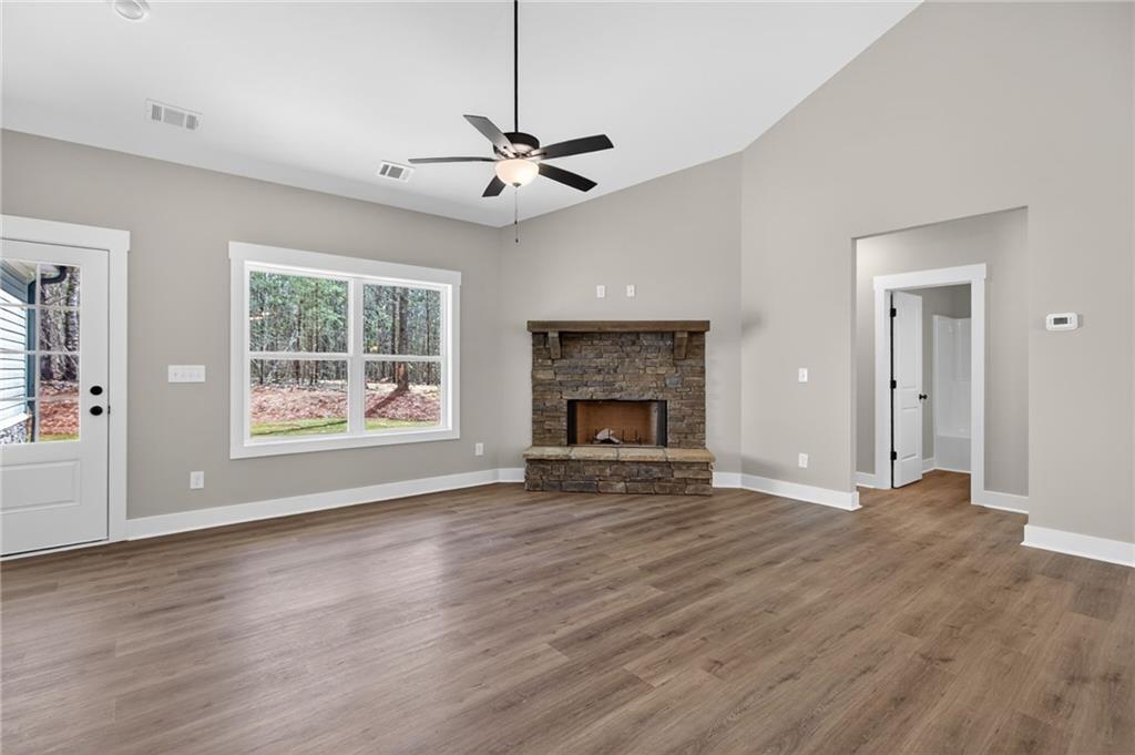 423 Relay Road Silver Creek, GA 30173 - Photo 23 of 48 a view of an empty room with wooden floor fireplace and a window