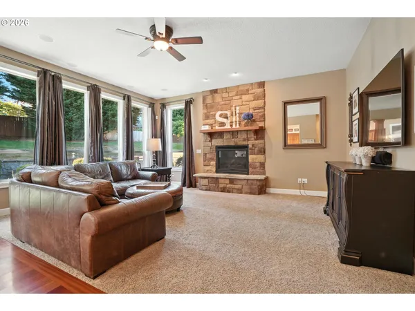a living room with furniture a flat screen tv and a large window
