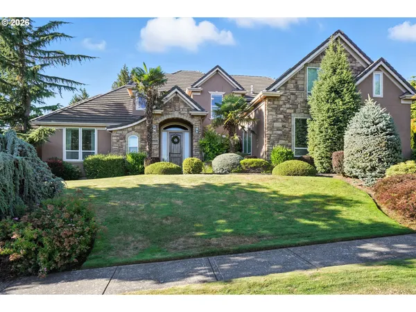 a front view of a house with a yard and garage