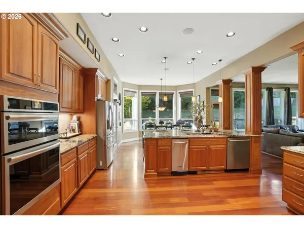 a kitchen with stainless steel appliances granite countertop a sink and refrigerator