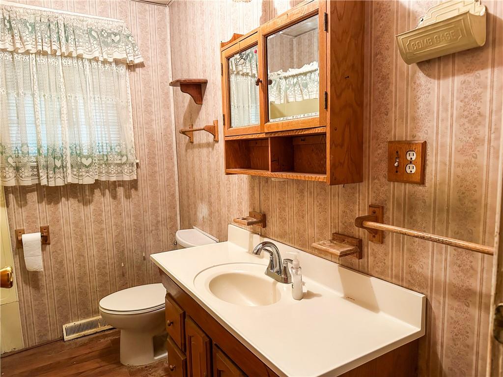 1173 Freeport Road Kittanning, PA 16201 - Photo 5 of 22 a bathroom with a sink a toilet and shower curtain