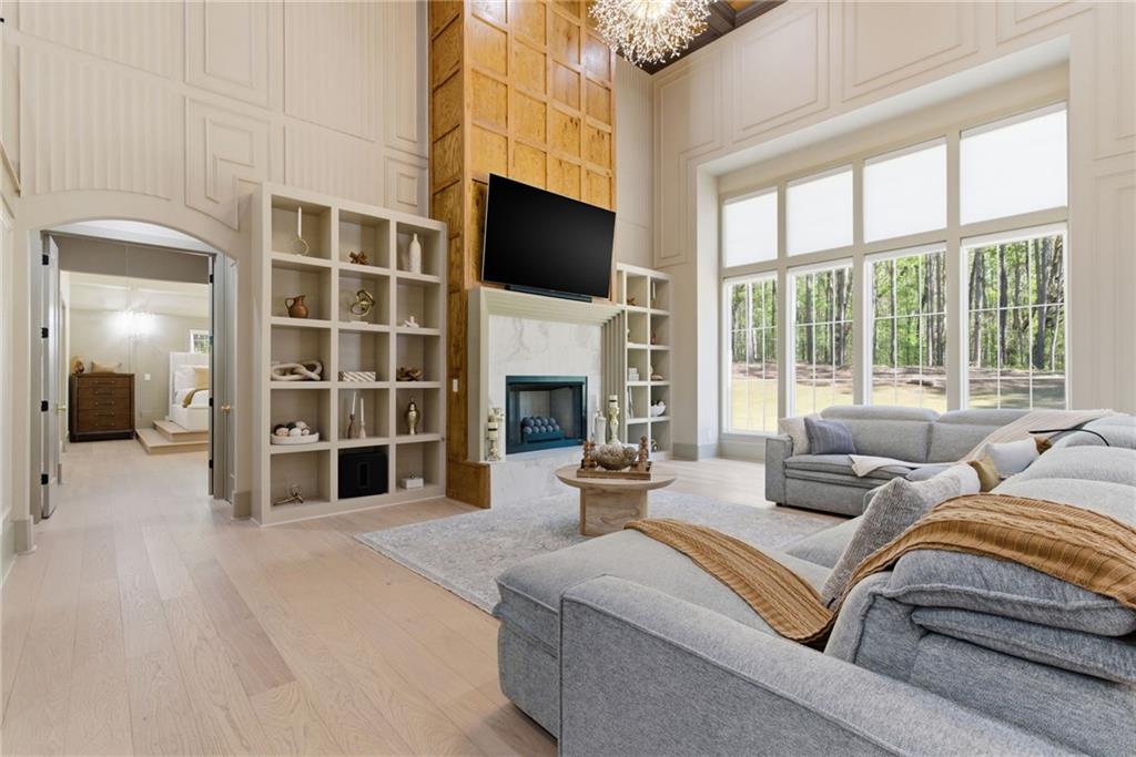 1315 Sandy Creek Road Fayetteville, GA 30214 - Photo 21 of 107 a living room with furniture a fireplace and a flat screen tv