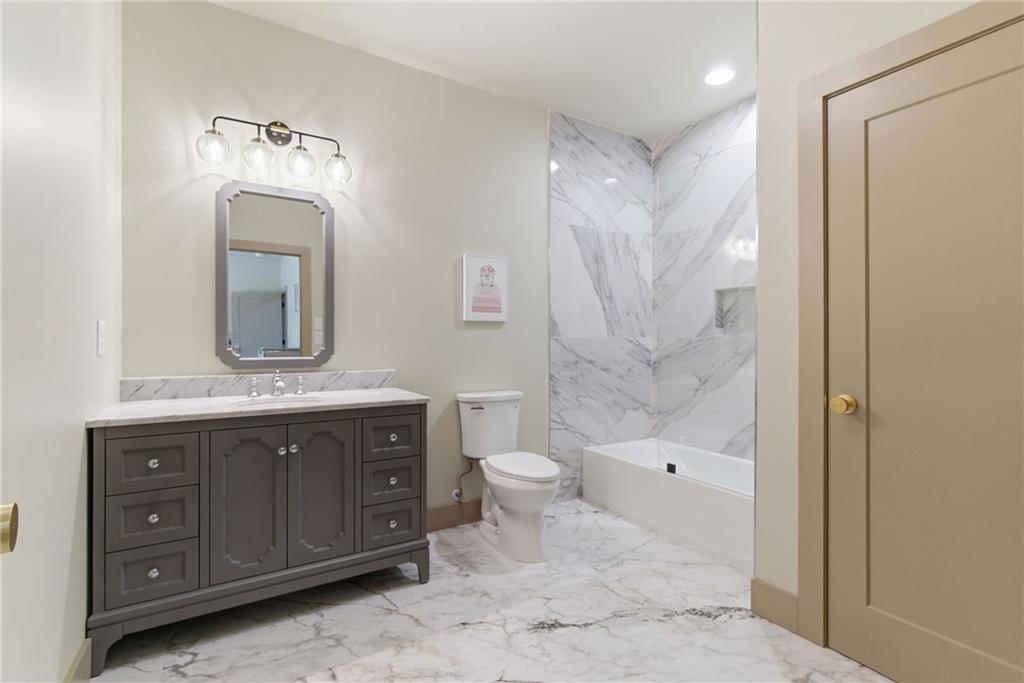 1315 Sandy Creek Road Fayetteville, GA 30214 - Photo 84 of 107 a bathroom with a granite countertop sink a toilet and a mirror