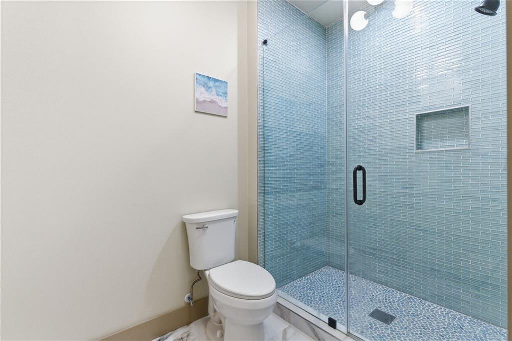 1315 Sandy Creek Road Fayetteville, GA 30214 - Photo 87 of 107 a white toilet sitting next to a shower