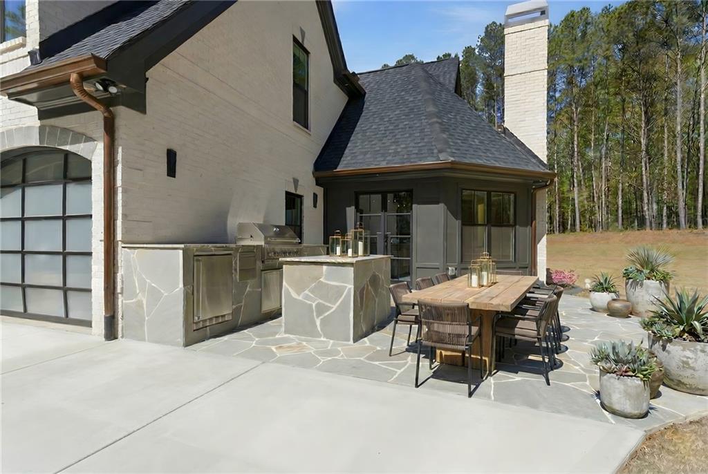 1315 Sandy Creek Road Fayetteville, GA 30214 - Photo 9 of 107 a view of a patio with table and chairs near a yard