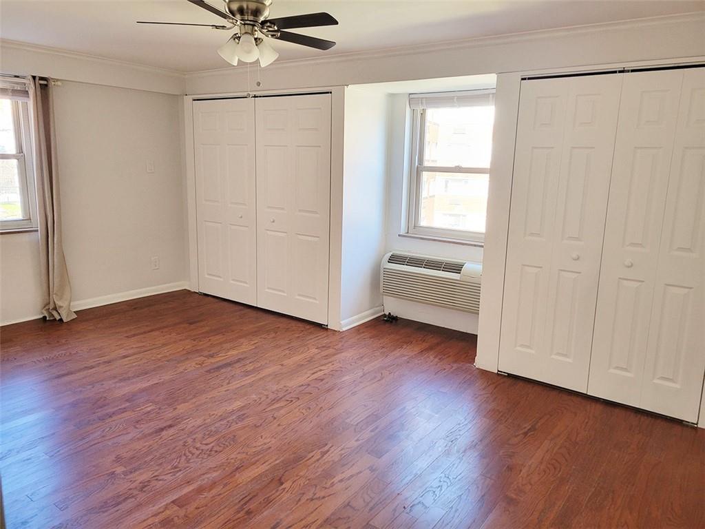 4601 Fifth Avenue, Unit 326 Pittsburgh, PA 15213 - Photo 13 of 20 an empty room with wooden floor closet and windows