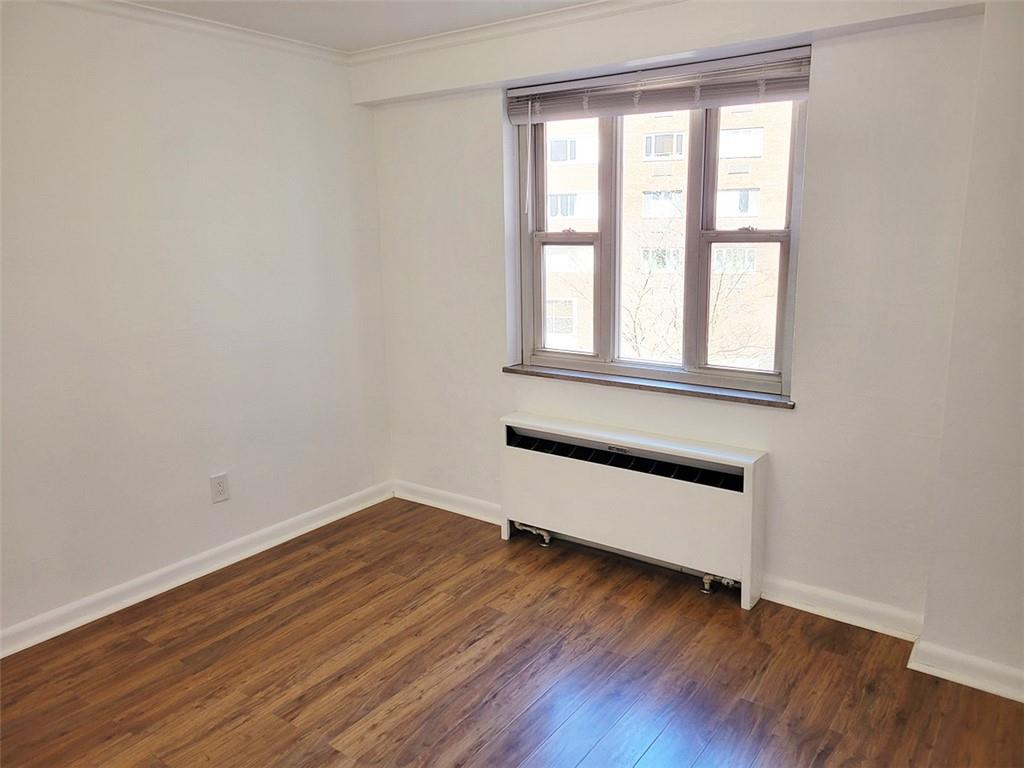 4601 Fifth Avenue, Unit 326 Pittsburgh, PA 15213 - Photo 6 of 20 an empty room with wooden floor and windows