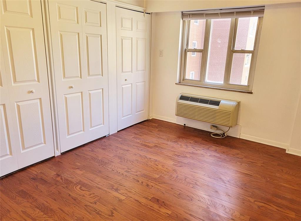 4601 Fifth Avenue, Unit 326 Pittsburgh, PA 15213 - Photo 10 of 20 an empty room with wooden floor and windows