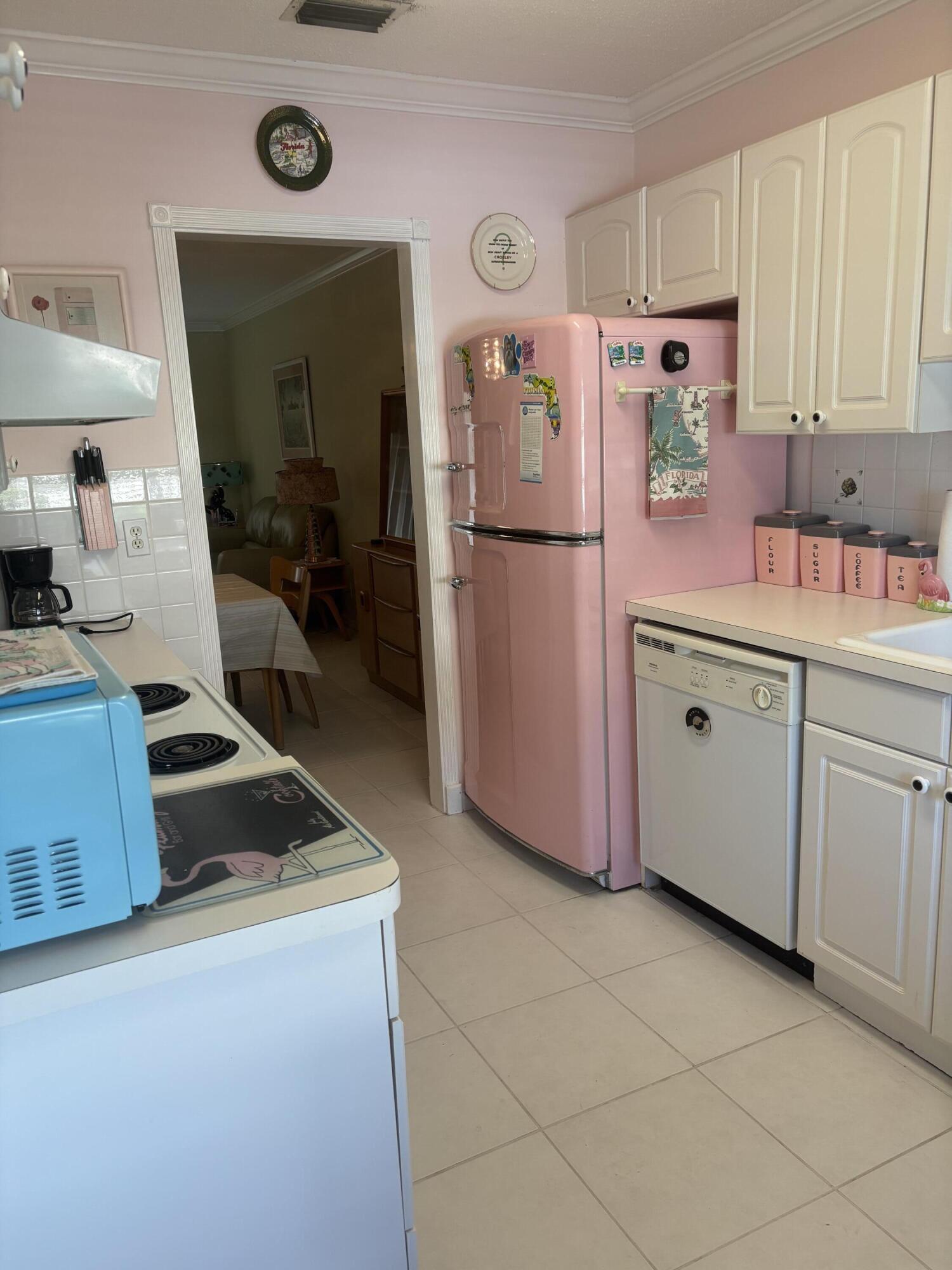 8608 Bella Vista Drive Boca Raton, FL 33433 - Photo 3 of 11 a kitchen with a refrigerator and a stove top oven