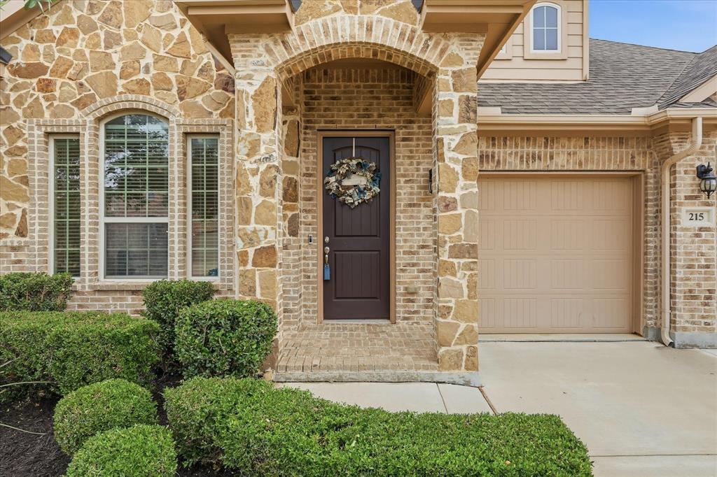 215 Equestrian Road Hickory Creek, TX 75065 - Photo 4 of 36 a front view of a house with a garden