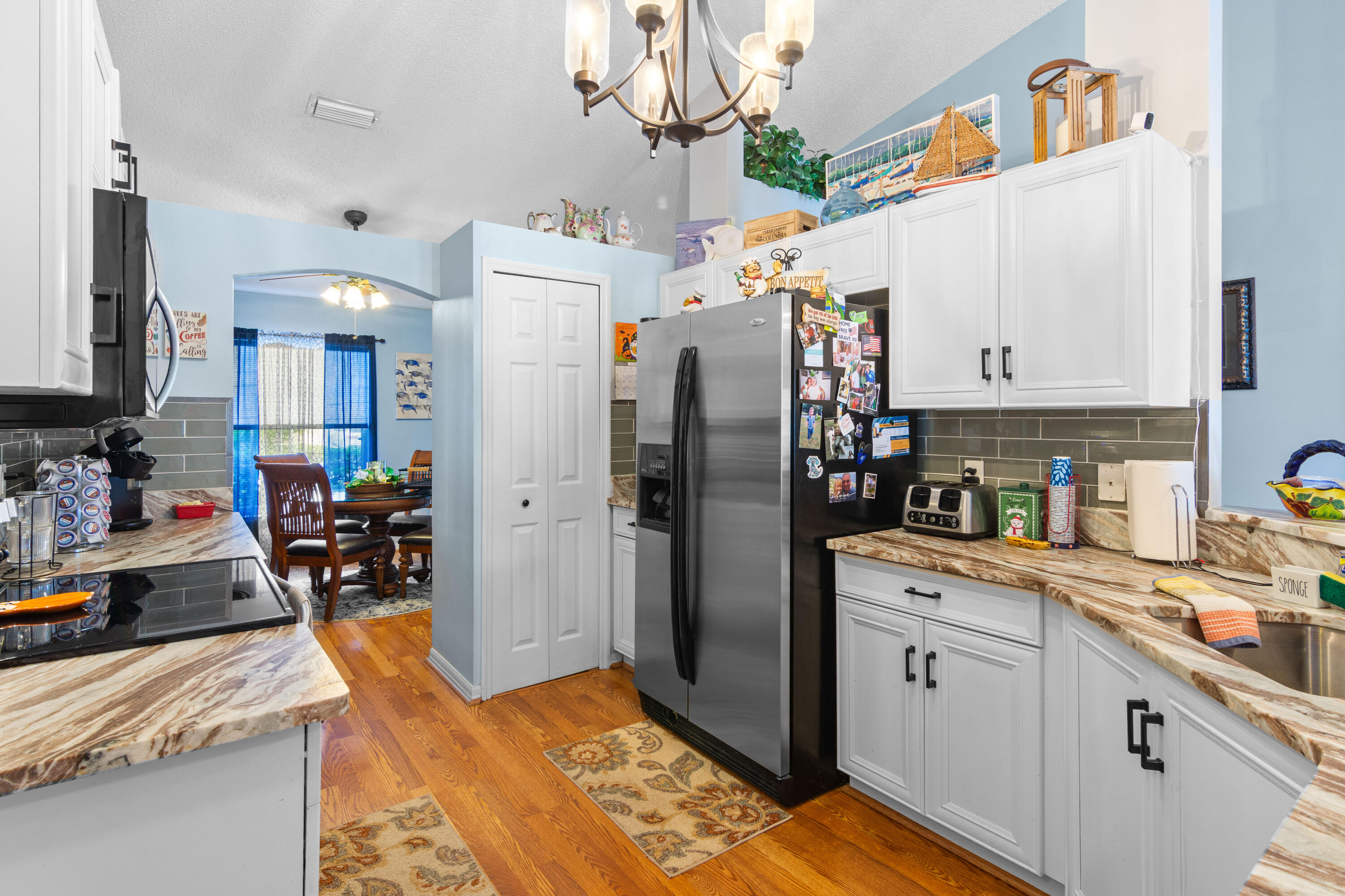 1817 Southwest Davis Street Port St. Lucie, FL 34953 - Photo 14 of 52 a kitchen with stainless steel appliances granite countertop a refrigerator and a stove top oven