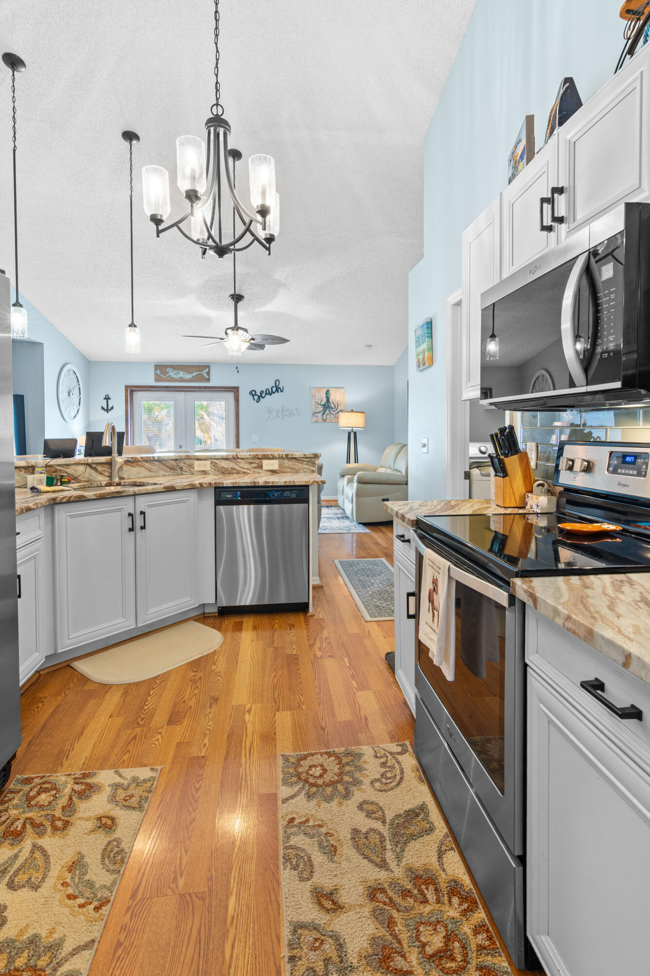 1817 Southwest Davis Street Port St. Lucie, FL 34953 - Photo 15 of 52 a kitchen with stainless steel appliances granite countertop a sink and stove top oven