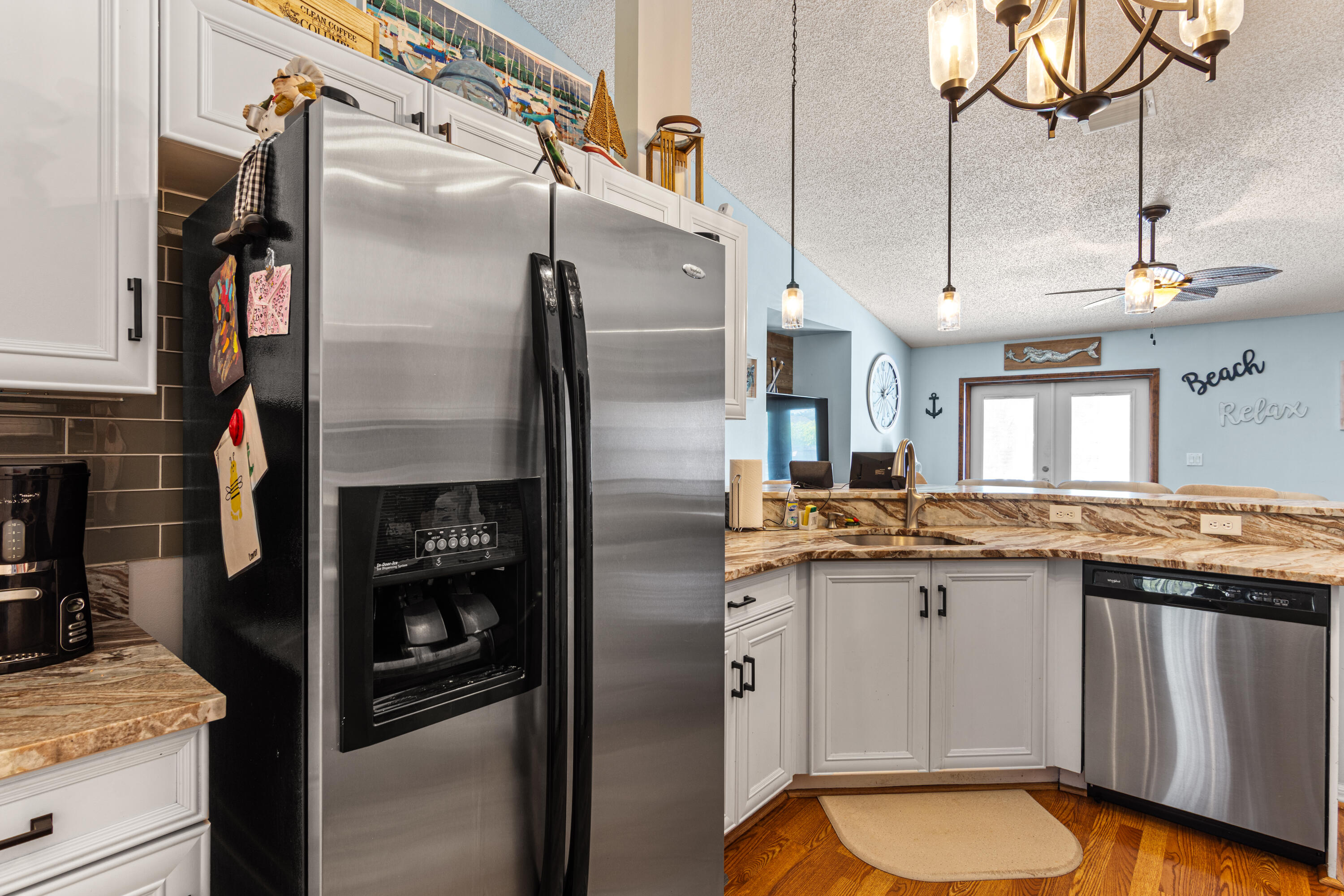 1817 Southwest Davis Street Port St. Lucie, FL 34953 - Photo 16 of 52 a kitchen with stainless steel appliances granite countertop a refrigerator a sink and white cabinets
