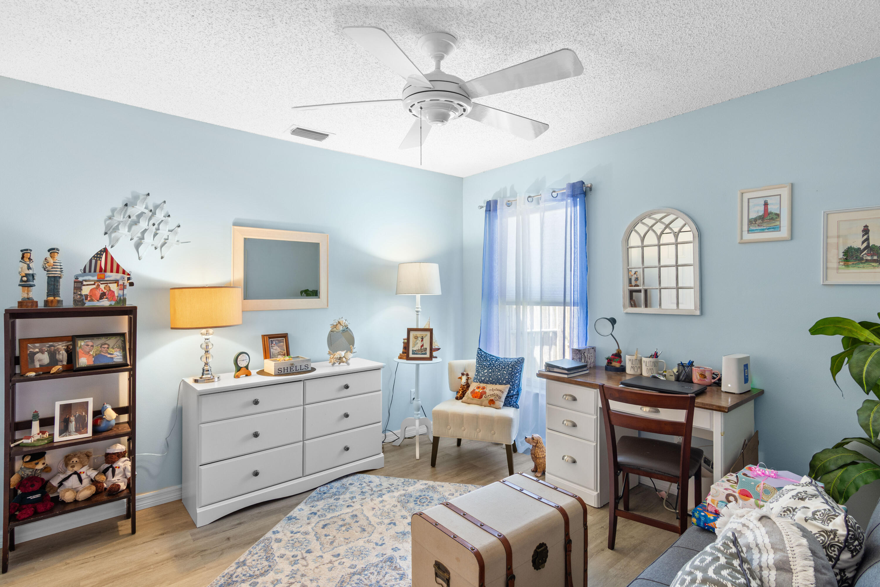 1817 Southwest Davis Street Port St. Lucie, FL 34953 - Photo 19 of 52 a bedroom with a bed and a chandelier