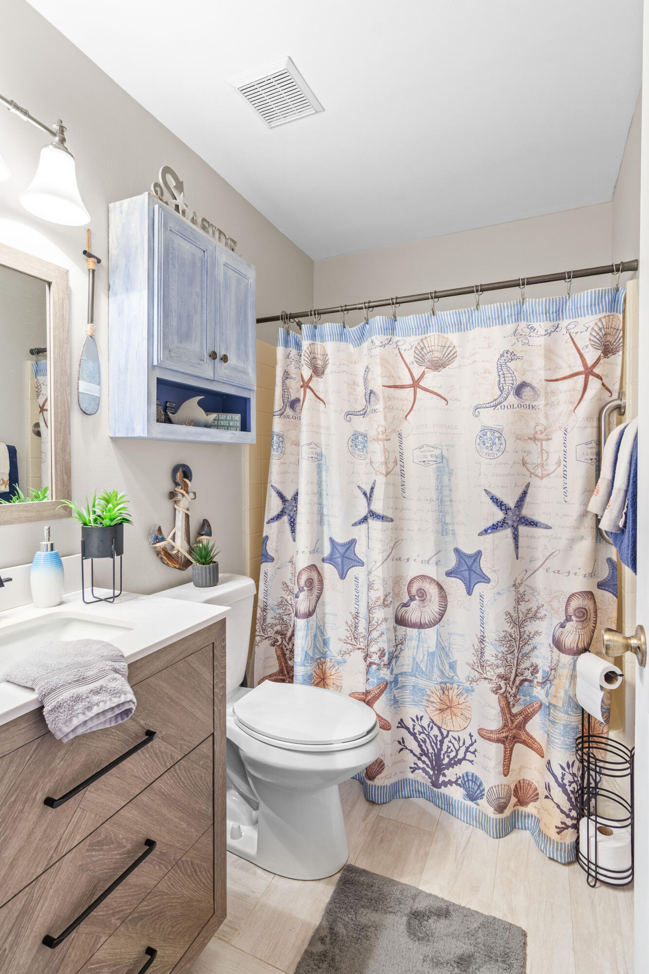 1817 Southwest Davis Street Port St. Lucie, FL 34953 - Photo 21 of 52 a bathroom with a granite countertop sink mirror vanity and toilet