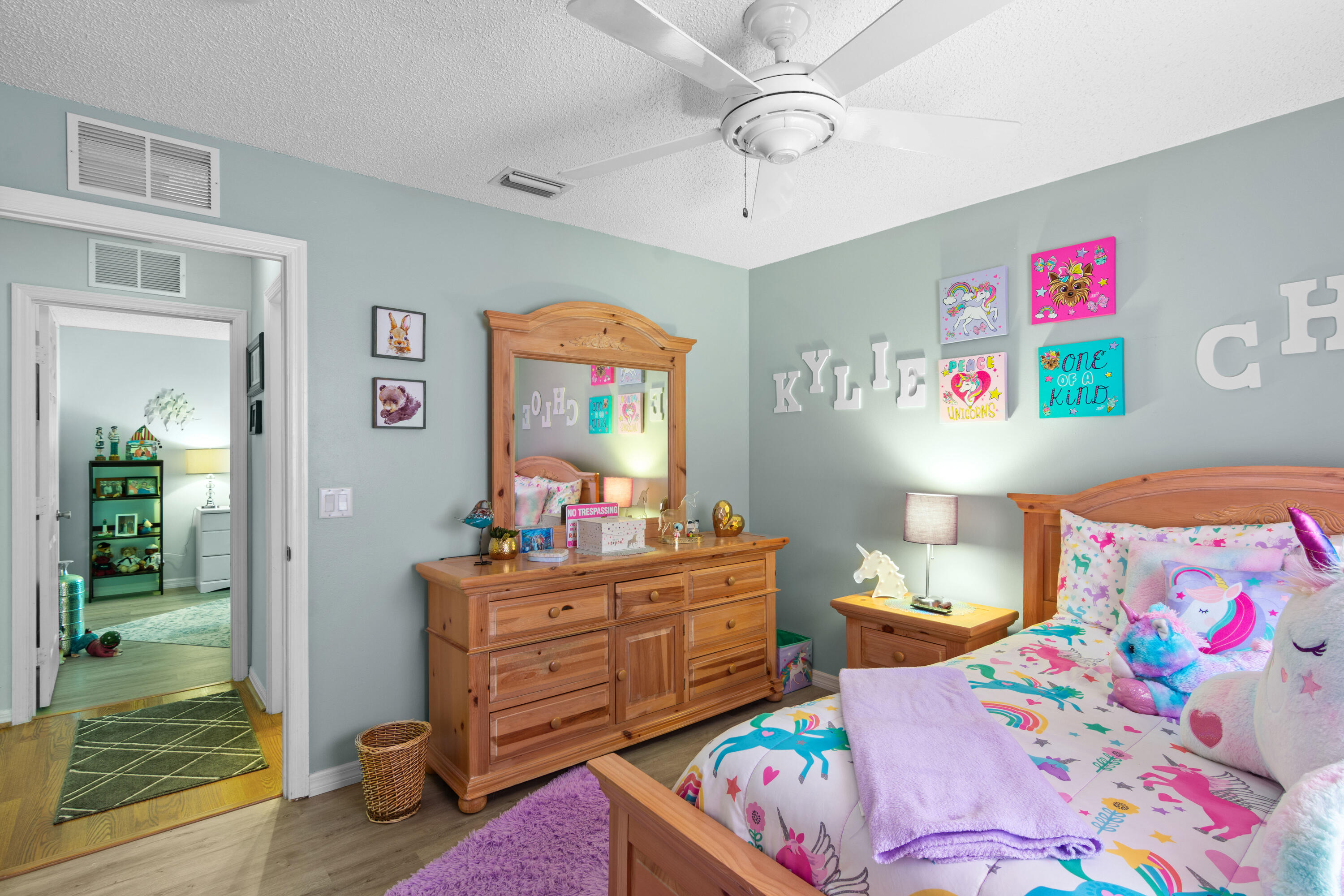 1817 Southwest Davis Street Port St. Lucie, FL 34953 - Photo 23 of 52 a bedroom with a bed and wooden floor