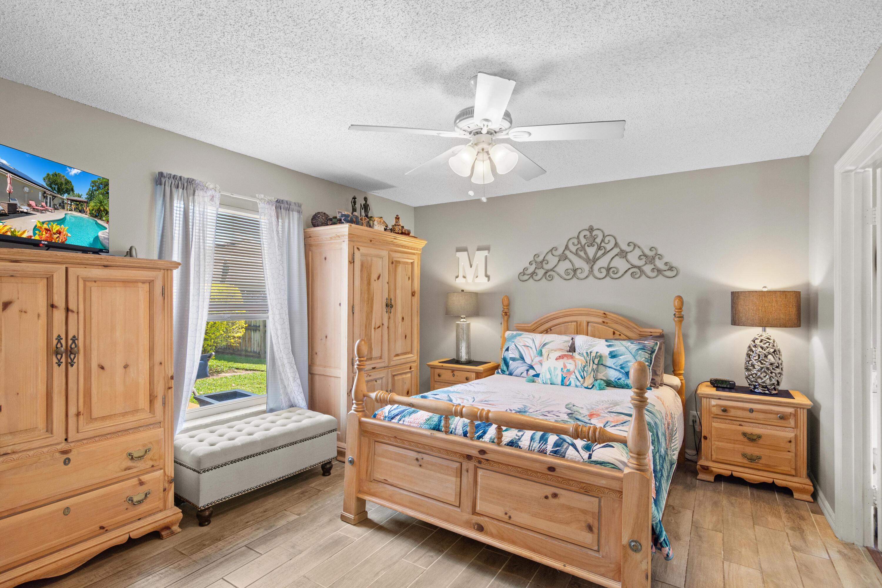 1817 Southwest Davis Street Port St. Lucie, FL 34953 - Photo 24 of 52 a bedroom with a bed and a couch