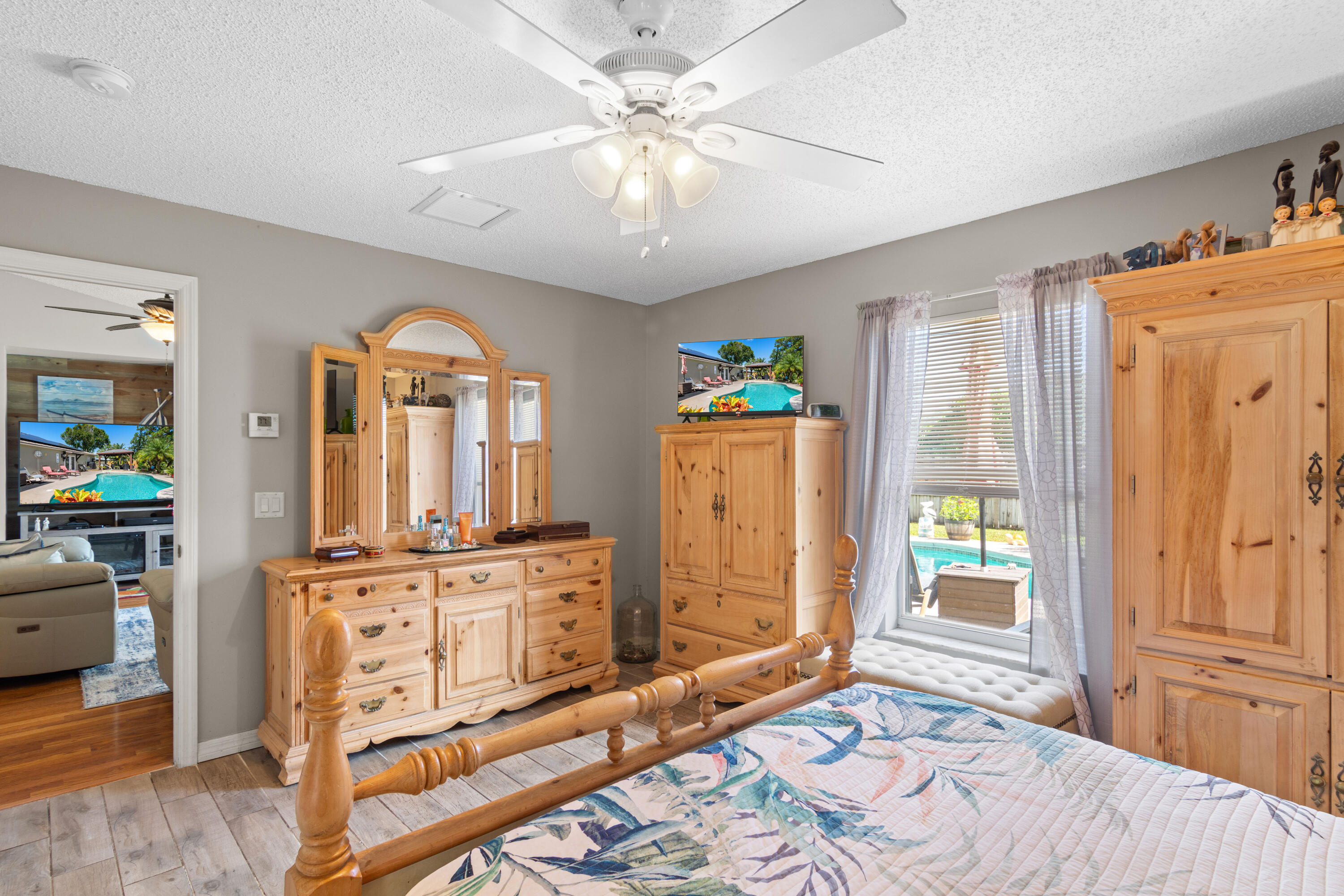 1817 Southwest Davis Street Port St. Lucie, FL 34953 - Photo 25 of 52 a bedroom with furniture and a wooden floor