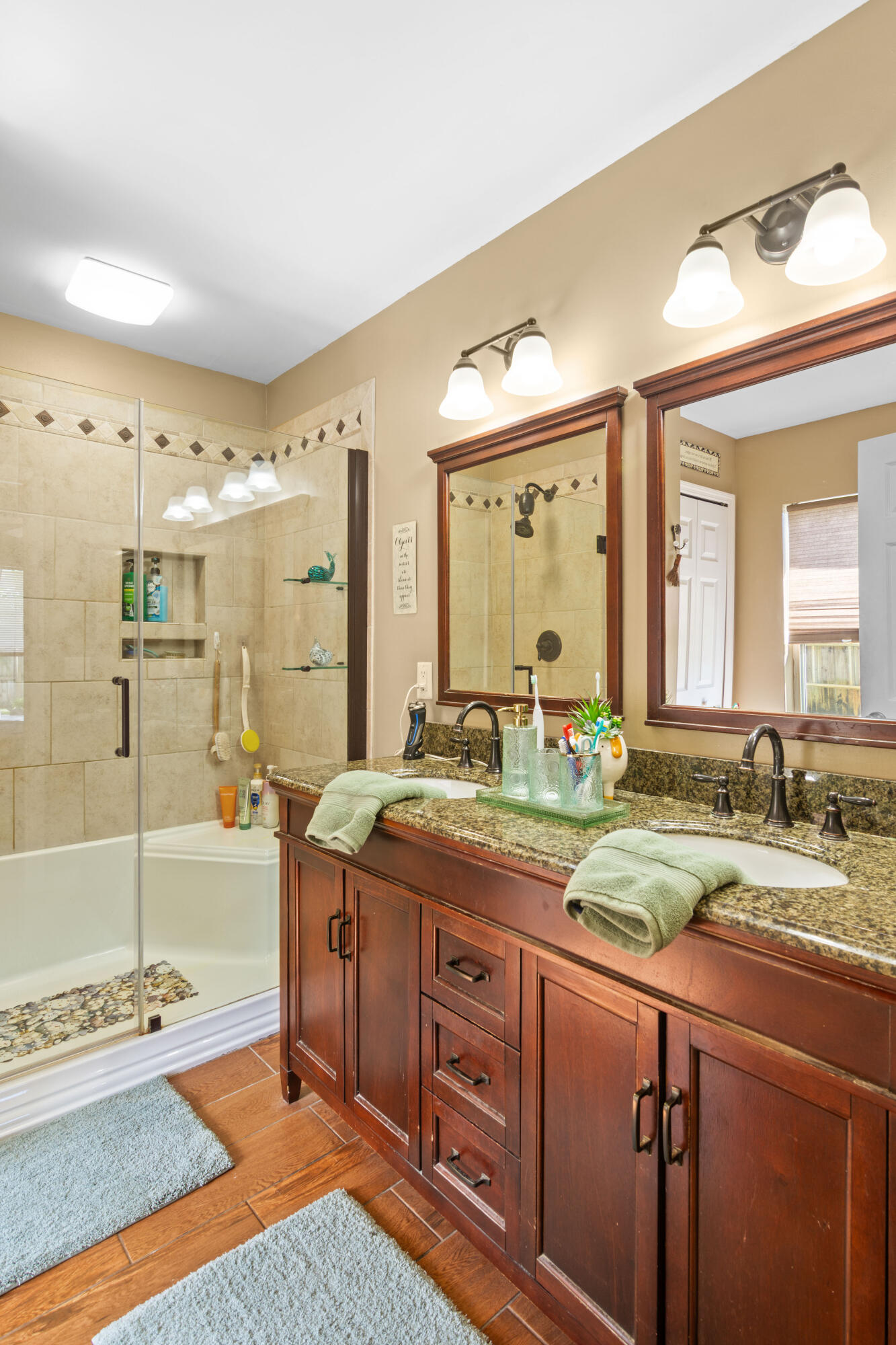 1817 Southwest Davis Street Port St. Lucie, FL 34953 - Photo 26 of 52 a spacious bathroom with a granite countertop sink mirror and shower