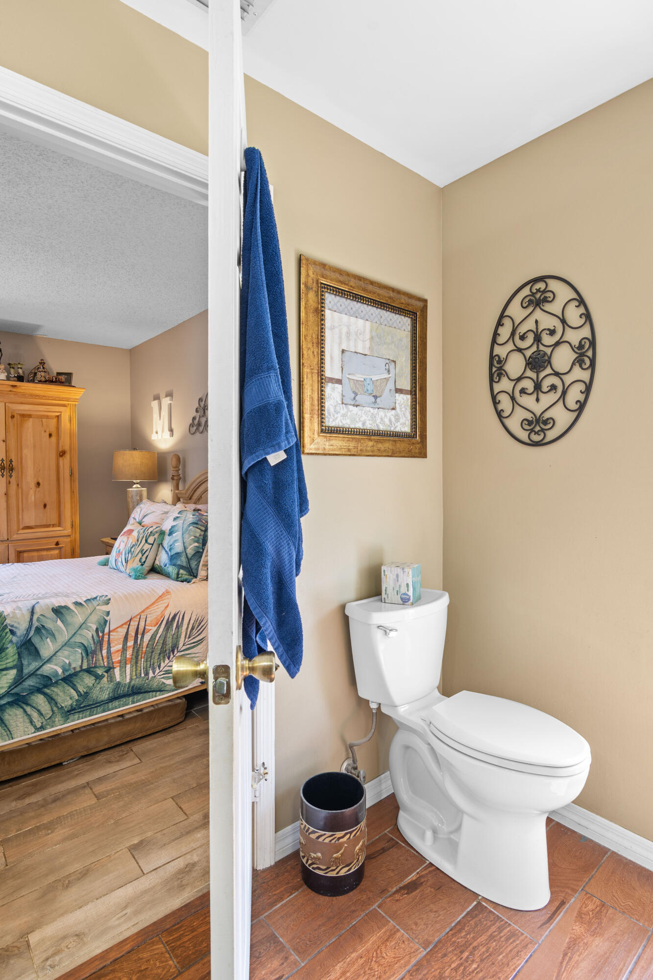 1817 Southwest Davis Street Port St. Lucie, FL 34953 - Photo 27 of 52 a bathroom with a toilet and a painting on the wall