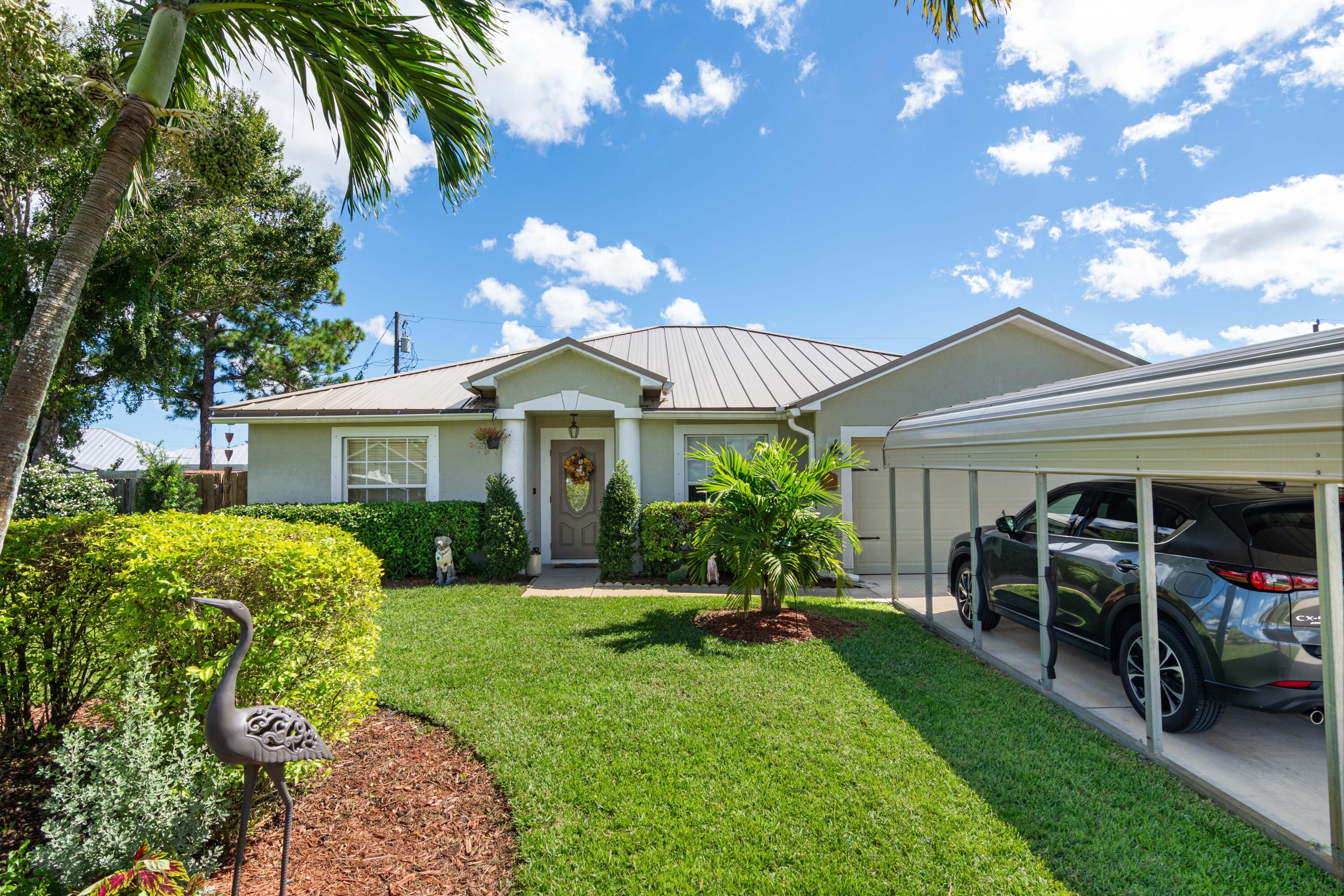 1817 Southwest Davis Street Port St. Lucie, FL 34953 - Photo 3 of 52 a front view of a house with a yard and porch