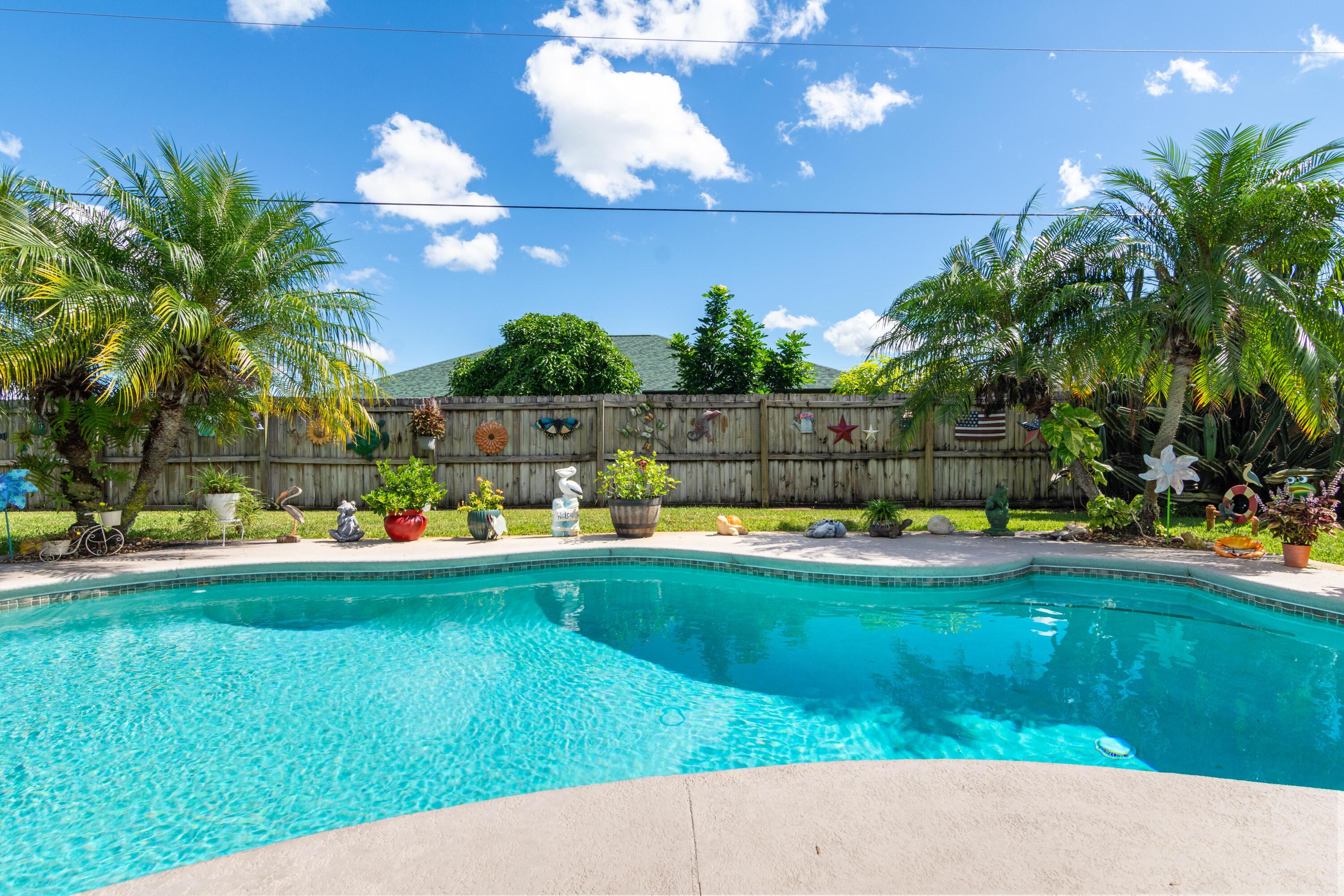 1817 Southwest Davis Street Port St. Lucie, FL 34953 - Photo 32 of 52 a view of a swimming pool and lounge chair