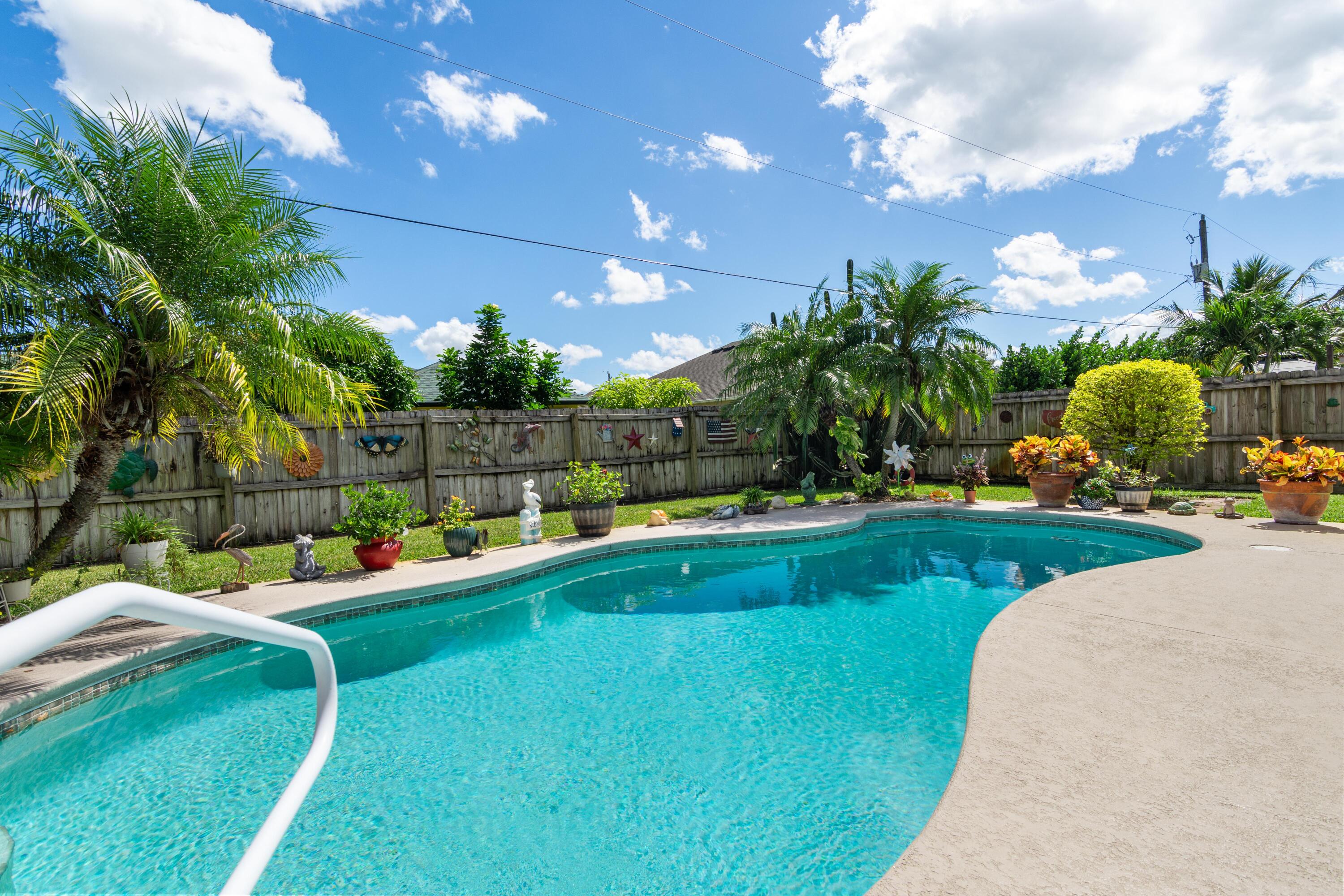 1817 Southwest Davis Street Port St. Lucie, FL 34953 - Photo 35 of 52 a view of a house with swimming pool and sitting area
